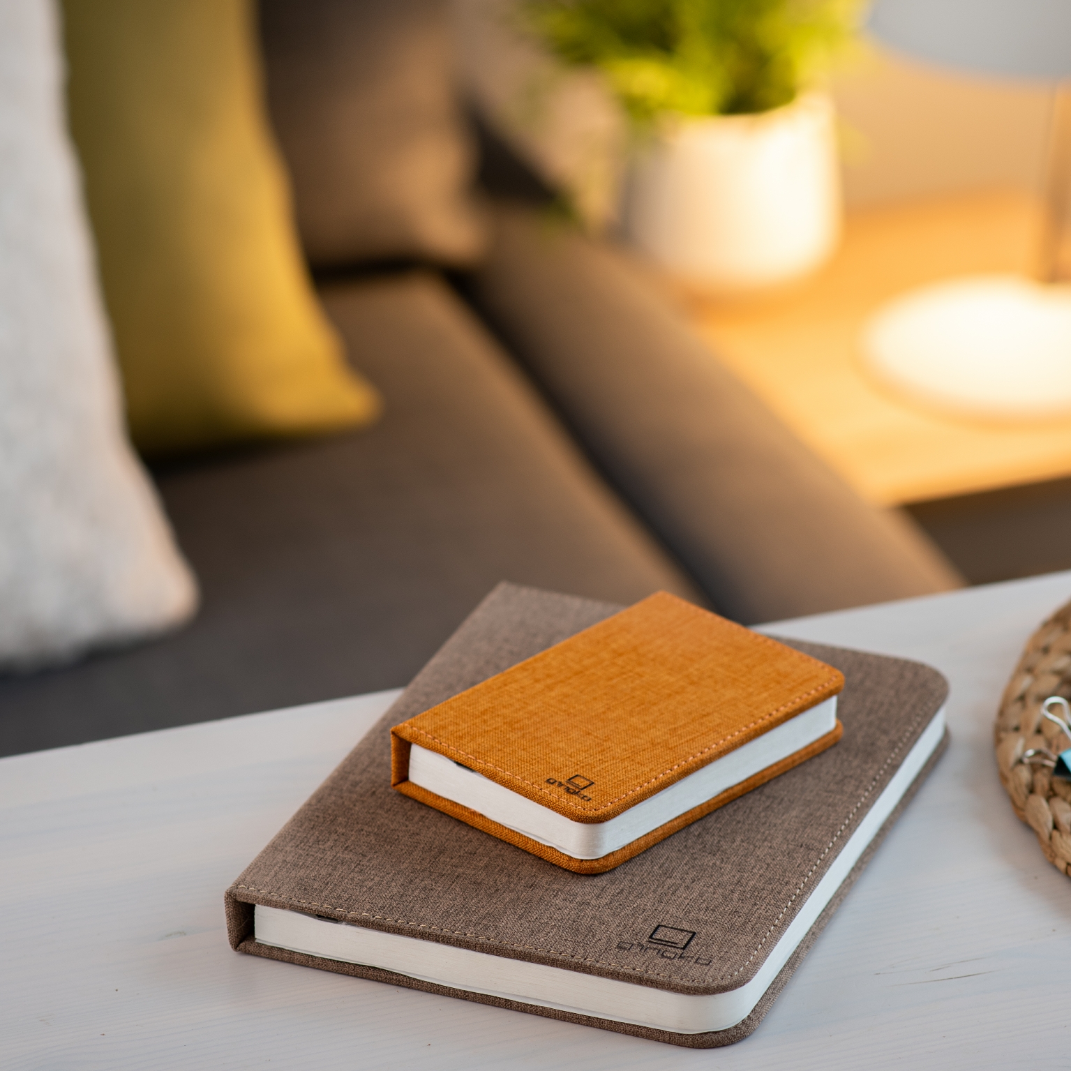 Gingko Mini Linen Smart Book Light16 Gingko smart mini book light in orange placed on larger book light