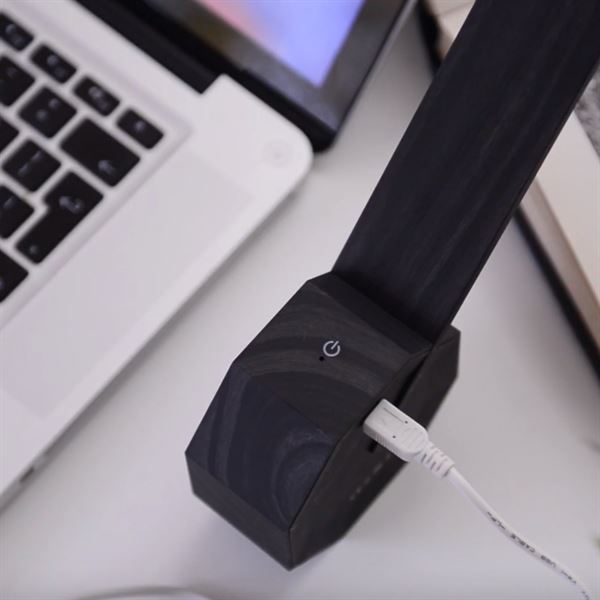 Gingko Octagon one desk lamp in Black connected to a charger